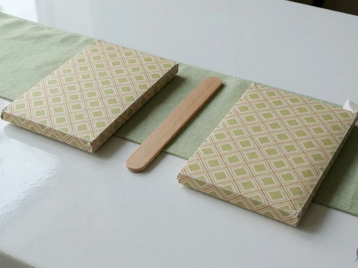 Two counted card packets facing each other on white lacquer